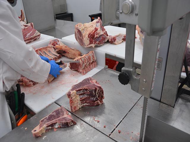 A meat cutter slices T-bone steaks at the Montana Premium Processing Cooperative in Havre, Montana, in 2023. The small co-op formed by 60 local producers and the Montana Farmers Union received a $292,000 grant under the Meat and Poultry Processing Expansion Program in late 2022 to help secure USDA meat inspection. (DTN file photo by Chris Clayton)