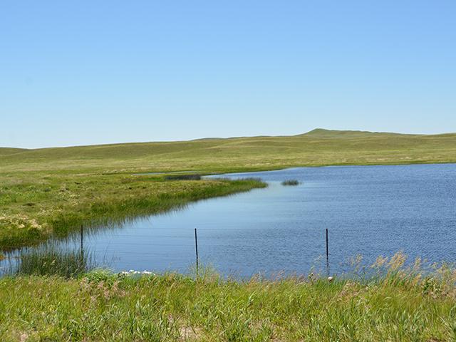 A wetland and pond along a rural highway in Wyoming. A year after EPA issued new waters of the U.S. (WOTUS) rules following the Sackett v. EPA ruling, farm groups and state regulators say they don't have guidance on rules and permits from EPA and the Army Corps of Engineers. (DTN file photo by Chris Clayton)