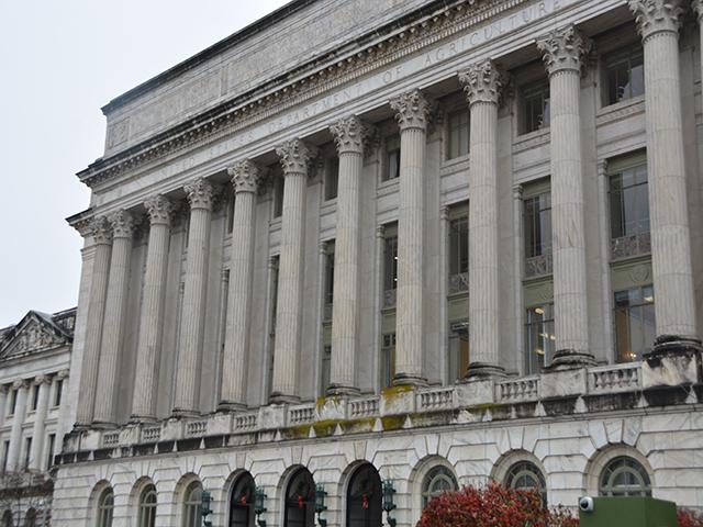 USDA's headquarters building in Washington, D.C., earlier this month. USDA will need to create rules to divvy up disaster aid and economic aid from the farm bill extension. Several USDA programs, however, also are now unauthorized to operate unless renewed in the next farm bill. (DTN photo by Chris Clayton)