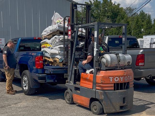 At right, Landon Miller, 17, of Morrow, Ohio, uses a forklift to load feed into the back of a customer's truck at Buckley Brothers, as part of the Little Miami School District and Panther Success Academy agricultural pre-apprenticeship career pathway. (Photo courtesy of Dustin Goldie)