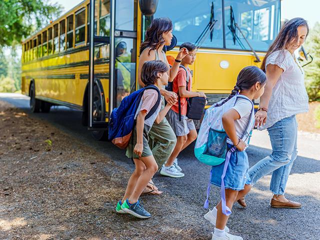 Rural schools face declining enrollment, funding gaps and teacher shortages but innovate through resource and bus sharing, community partnerships and place-based learning. (Fly View Productions, Getty Images)